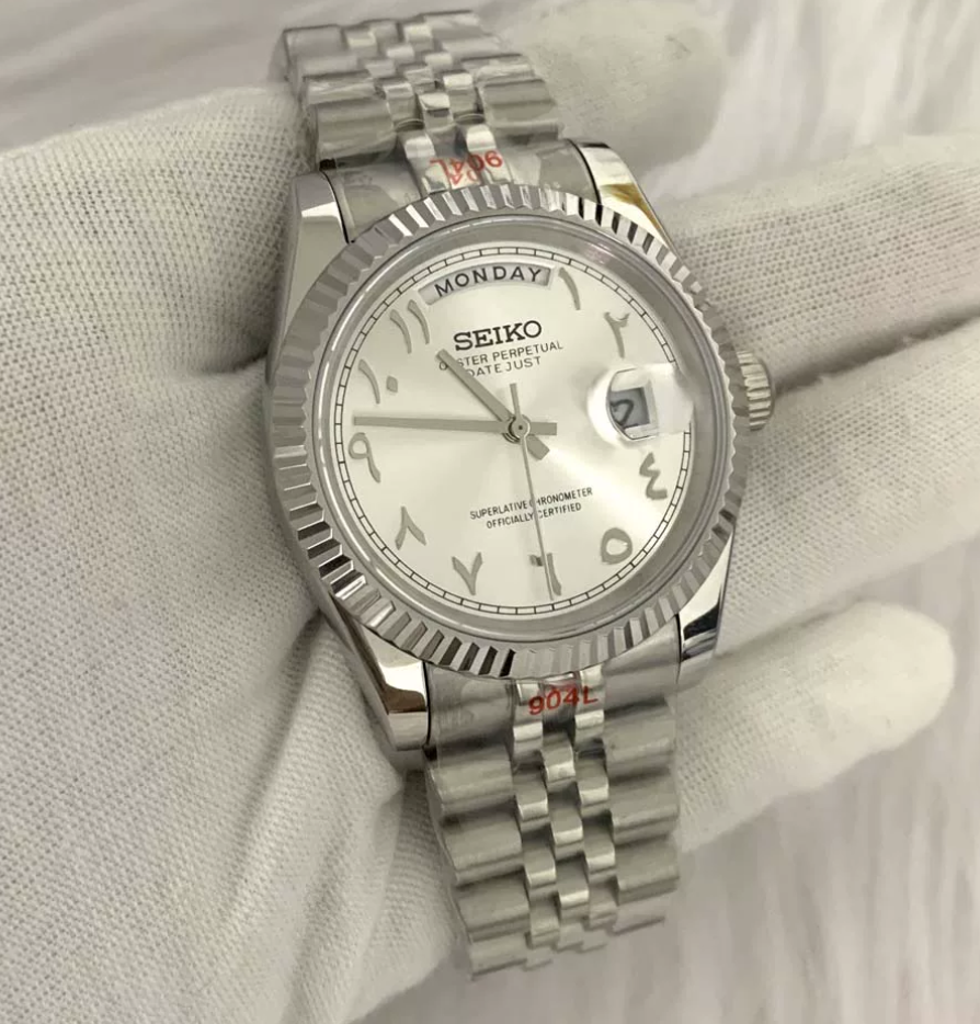 Day-Date Pearl — Fluted bezel, jubilee bracelet, white Arabic dial